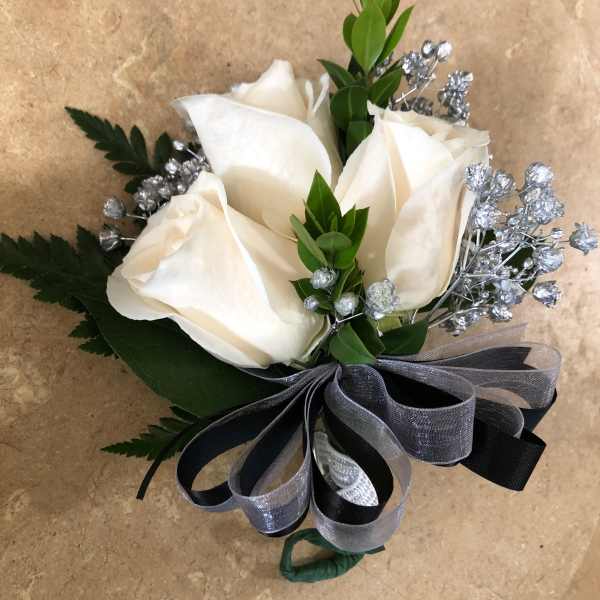 White rose boutonniere with silver filler and a black-gray ribbon
