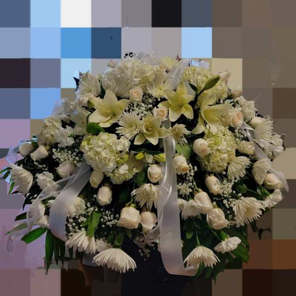 Large white floral arrangement with lilies, roses, and chrysanthemums