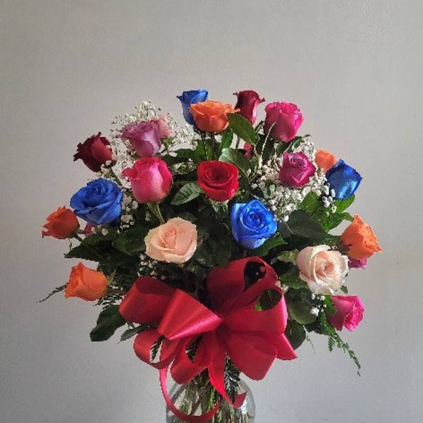 Mixed roses in a glass vase with a large red bow