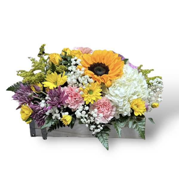 Mixed bouquet in a wooden box with sunflowers, roses, hydrangea, and daisies