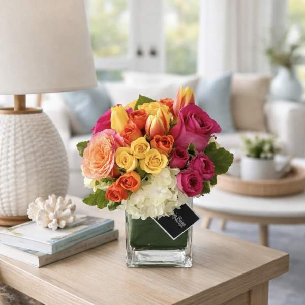 Colorful bouquet of roses and tulips in a glass vase