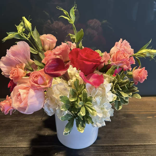Pink and red mixed bouquet in a white vase