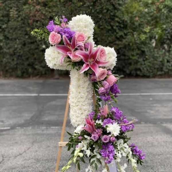 Tall floral standing spray with pink lilies, roses, and white blooms