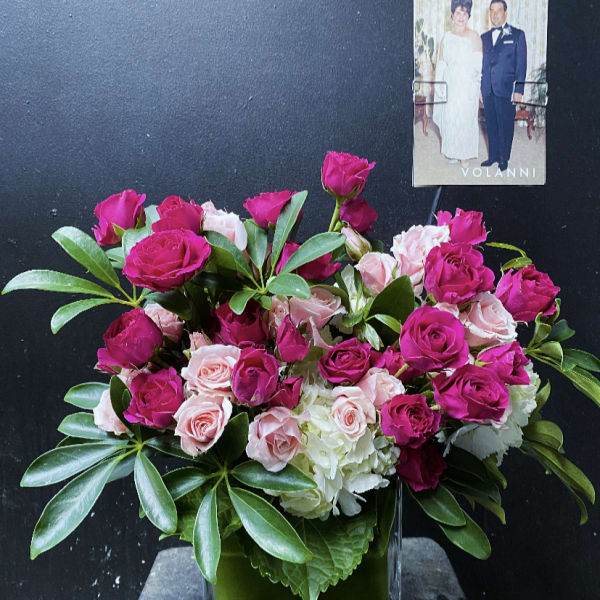 Pink and pale roses arranged in a clear square vase