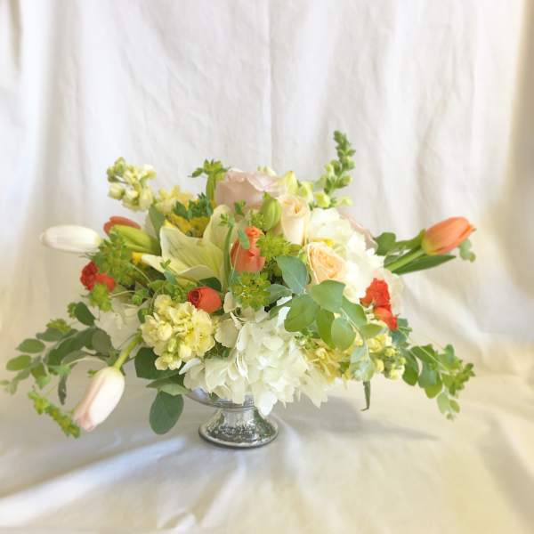Mixed bouquet in a silver pedestal vase with white and peach flowers