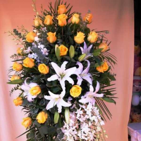 Standing floral spray with yellow roses and white lilies