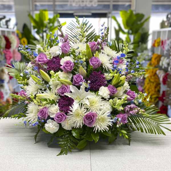 Lavender roses and white lilies in a low floral arrangement