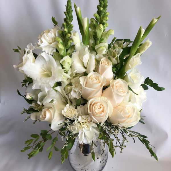 White and cream floral arrangement in a silver vase