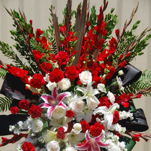 Large red and white standing floral spray with lilies and roses
