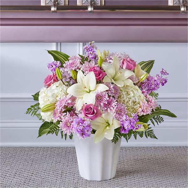 Pink and white floral arrangement in a white vase