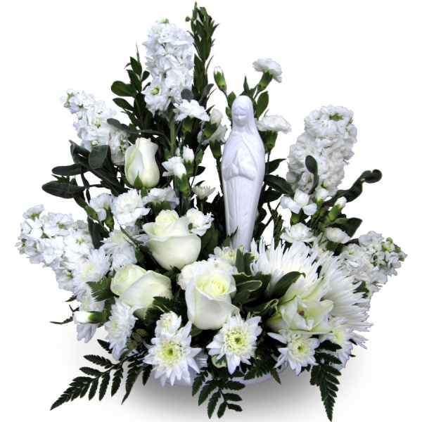 White floral arrangement with a small religious statue in the center