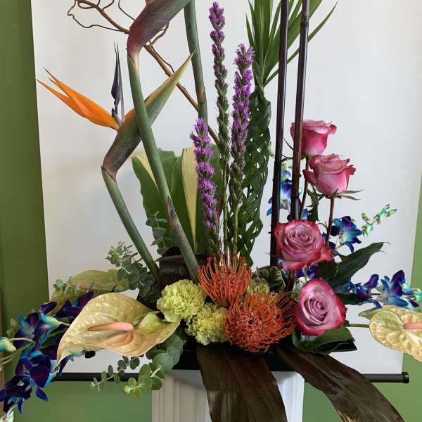 Tall tropical arrangement with pink roses and orange bird-of-paradise flowers