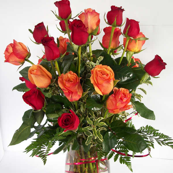 Bouquet of red and orange roses in a clear glass vase