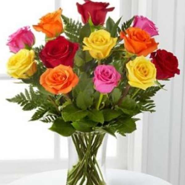 Bouquet of multicolored roses in a clear glass vase