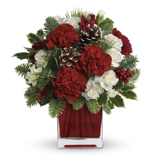 Red and white floral arrangement in a clear square vase