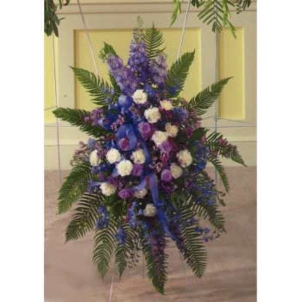 Standing spray of purple and white flowers with fern fronds