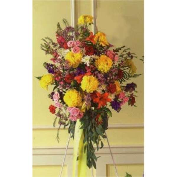 Tall colorful floral standing spray on an easel
