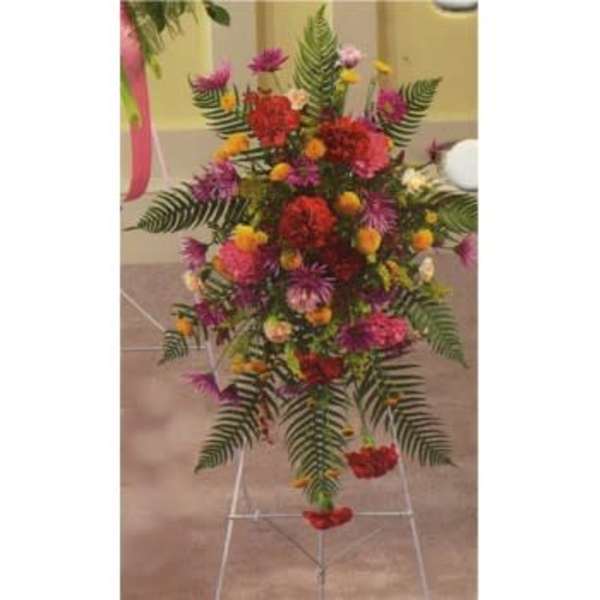 Tall floral standing spray with red, pink, and purple flowers
