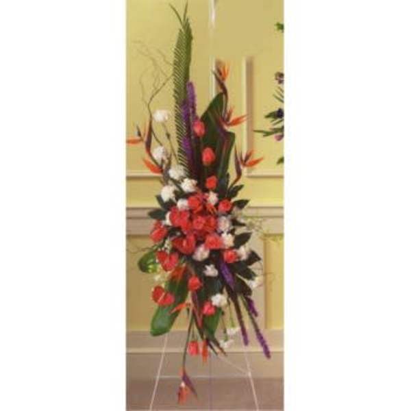 Tall tropical floral arrangement with red, white, and purple blooms