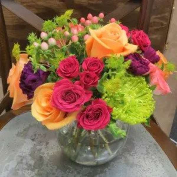 Bouquet of multicolored roses in a clear glass vase