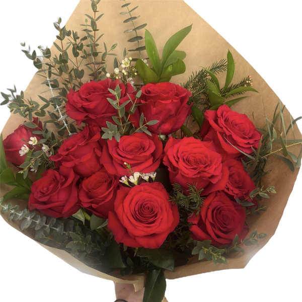 Bouquet of red roses with greenery wrapped in brown paper