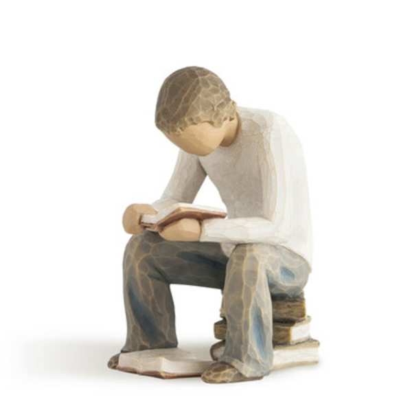 Wooden figurine of a seated person reading a book