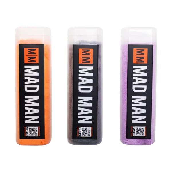 Three labeled bottles of colored powder in orange, black, and purple
