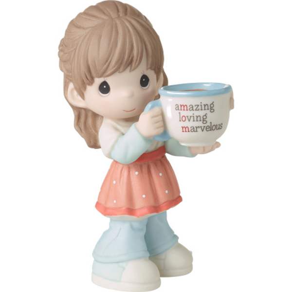 Small figurine of a girl holding a mug with text