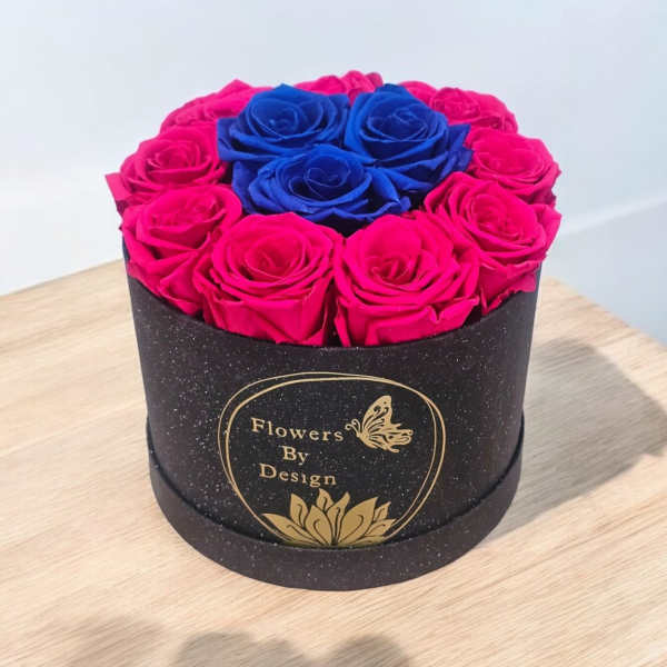 Round box of pink and blue roses on a table