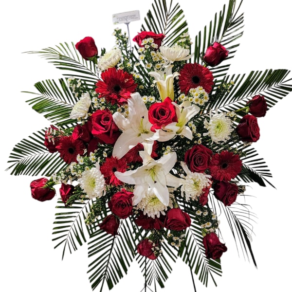 Standing floral spray with red roses, white lilies, and gerbera daisies