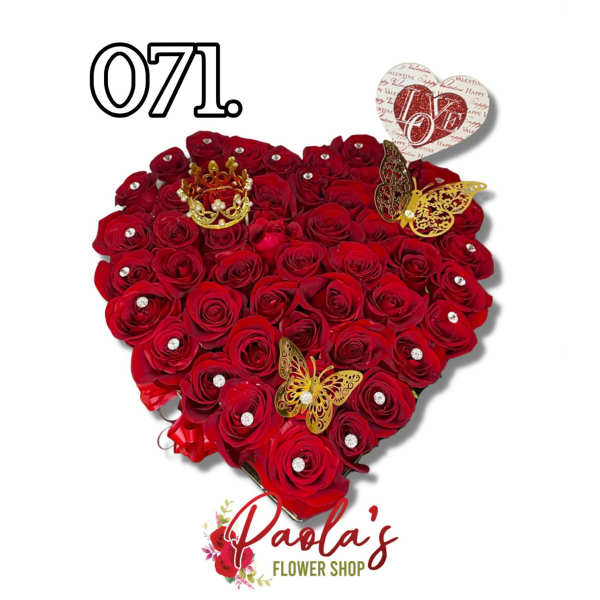 Heart-shaped bouquet of red roses with decorative butterflies and a crown