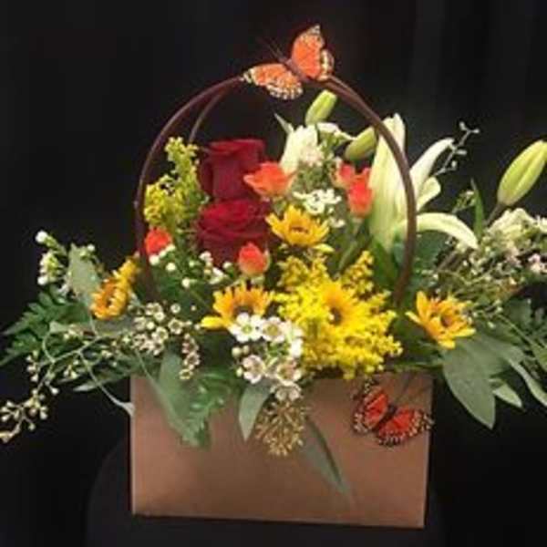 Mixed flower basket with roses, lilies, and butterflies