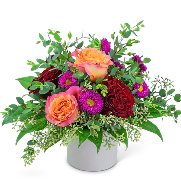 Bouquet of orange and red roses with purple daisies in a white vase