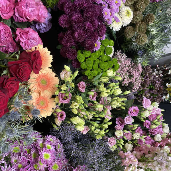 Assorted bouquets of roses, chrysanthemums, and gerbera daisies in bright colors