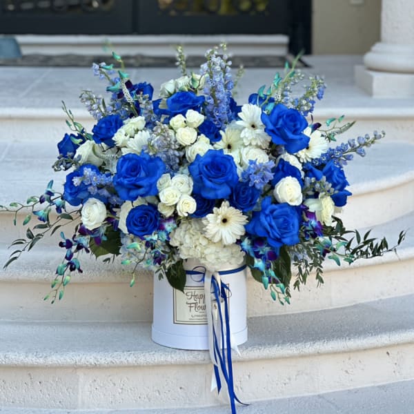 Blue and white rose bouquet in a white hat box with ribbon