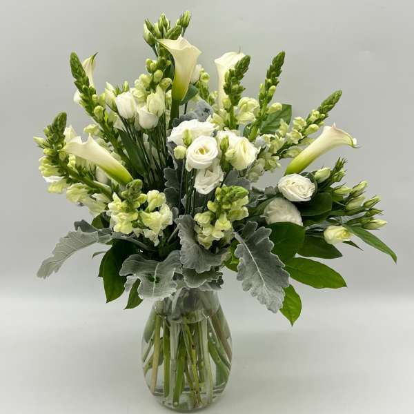 White floral bouquet in a clear glass vase