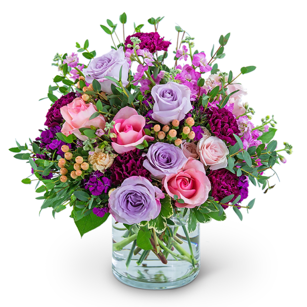 Bouquet of pink and lavender roses in a clear glass vase
