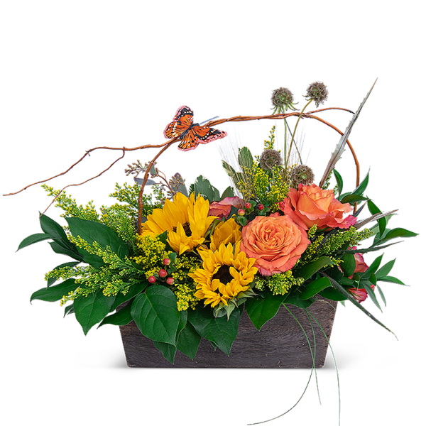 Sunflowers and orange roses in a rectangular basket with a butterfly pick