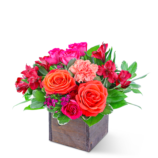 Mixed pink and orange flowers in a wooden box