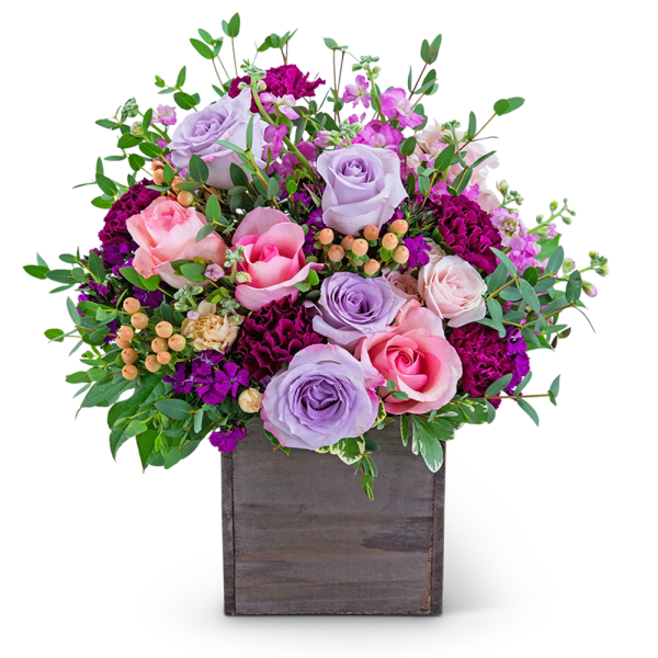 Lavender and pink roses in a wooden box with greenery