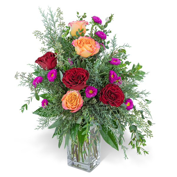 Bouquet of red and peach roses in a clear glass vase