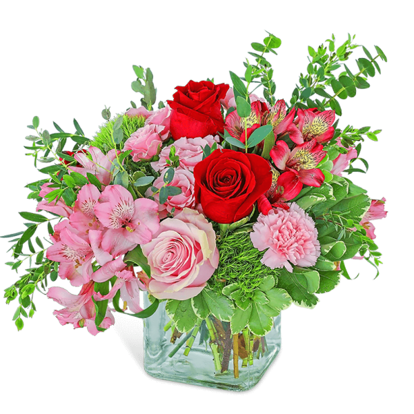 Pink and red mixed bouquet in a clear glass vase