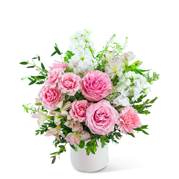 Pink roses and white flowers arranged in a white vase
