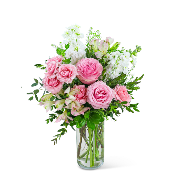 Pink roses and white flowers arranged in a clear glass vase