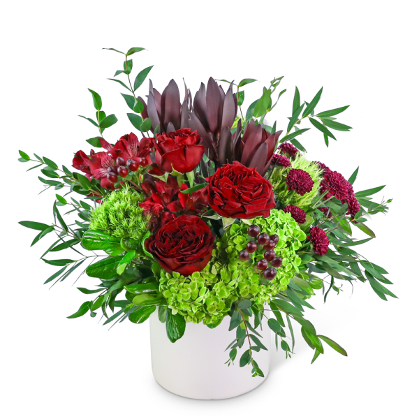 Red roses and green hydrangeas in a white vase