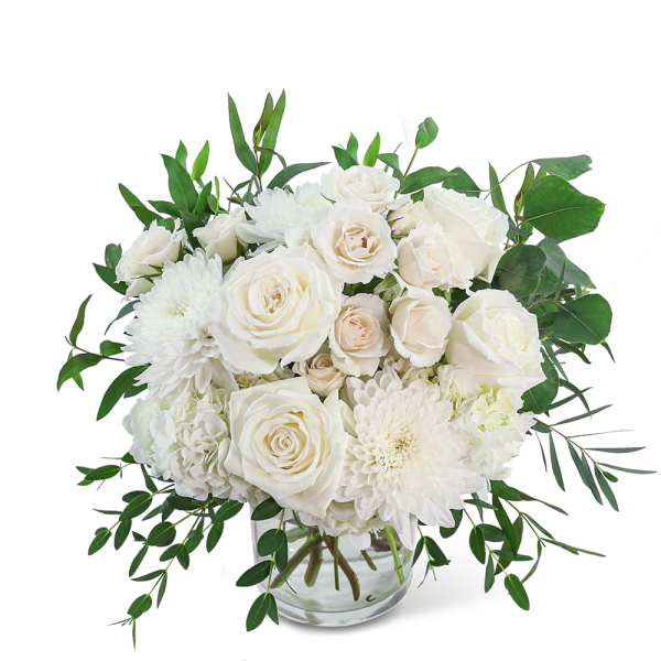 White roses and chrysanthemums in a clear glass vase