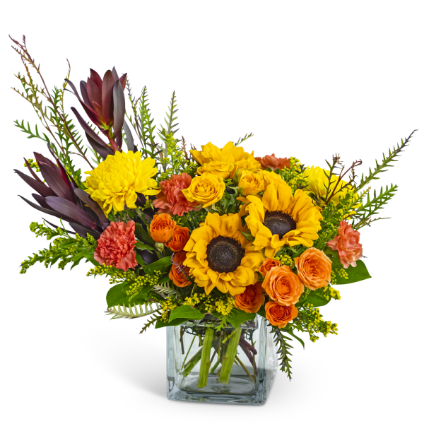 Sunflowers and orange roses in a clear glass vase