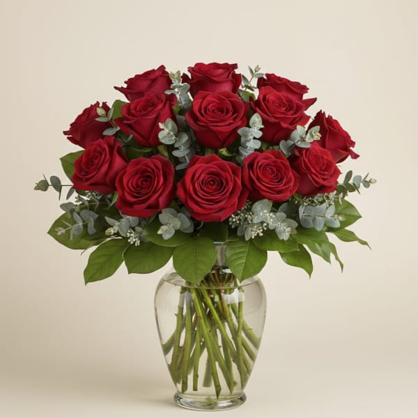Red roses arranged in a clear glass vase