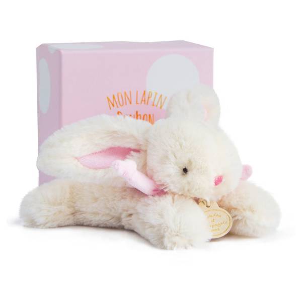 Plush white bunny toy in front of a pink gift box