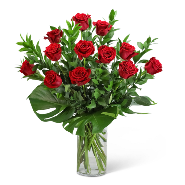Red roses arranged in a clear glass vase